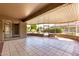 Spacious covered patio with tile flooring and views of the lush backyard at 15801 W Goldenrod Dr, Surprise, AZ 85374