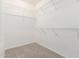 Walk-in closet with carpet flooring and wire shelving, providing ample storage space at 15801 W Goldenrod Dr, Surprise, AZ 85374