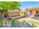 Charming backyard featuring a colorful playhouse and well-maintained landscaping at 16425 N 46Th Dr, Glendale, AZ 85306