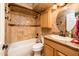 Bathroom with a shower-tub combo, single sink vanity, and earth-toned tile at 16425 N 46Th Dr, Glendale, AZ 85306