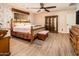 Bedroom featuring floral wallpaper, wood flooring and a ceiling fan at 16425 N 46Th Dr, Glendale, AZ 85306