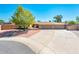 Charming home featuring a well-manicured lawn, a spacious driveway, and a welcoming two-car garage at 16425 N 46Th Dr, Glendale, AZ 85306