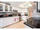 The spacious kitchen features stainless steel appliances, custom backsplash and bright lighting at 16425 N 46Th Dr, Glendale, AZ 85306
