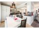 Bright kitchen features white cabinets, granite countertops, and a dining area at 16425 N 46Th Dr, Glendale, AZ 85306