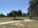 Scenic view of Sunburst Paradise Park with lush greenery, walking paths, and benches under a clear blue sky at 16425 N 46Th Dr, Glendale, AZ 85306