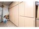 Spacious storage area with light colored, built-in storage cabinets at 16425 N 46Th Dr, Glendale, AZ 85306