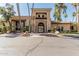Desert community clubhouse featuring palm trees, tile roof, arched entrance, and stucco exterior at 16747 W Berkeley Rd, Goodyear, AZ 85395