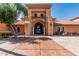 Beautiful clubhouse entrance with an arched doorway, columns, and terra cotta tiled roof at 16747 W Berkeley Rd, Goodyear, AZ 85395