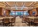 Spacious event space with tables, chairs, and large windows with golf course views at 16747 W Berkeley Rd, Goodyear, AZ 85395