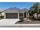 Charming single-story home with a desert landscape, a three-car garage, and a warm, inviting facade at 16747 W Berkeley Rd, Goodyear, AZ 85395