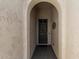 Arched entry leads to a solid front door, offering a glimpse of the home's inviting entrance at 16747 W Berkeley Rd, Goodyear, AZ 85395