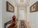 Elegant hallway featuring tile flooring, decorative art, and a stylish table with a striking vase at 16747 W Berkeley Rd, Goodyear, AZ 85395