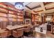 Cozy library featuring a fireplace, built-in bookshelves, and comfortable seating at 16747 W Berkeley Rd, Goodyear, AZ 85395