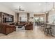 Inviting living room with tile flooring, ceiling fan, comfortable seating, and access to the dining area at 16747 W Berkeley Rd, Goodyear, AZ 85395