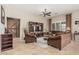 Cozy living room with a barn door accent, TV, ceiling fan, comfortable seating, and plenty of natural light at 16747 W Berkeley Rd, Goodyear, AZ 85395