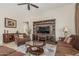Inviting living room with a TV entertainment center, comfortable seating, a ceiling fan, and a nearby hallway entrance at 16747 W Berkeley Rd, Goodyear, AZ 85395