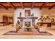 Lobby featuring tile floors, neutral seating around a fireplace, and rustic decor at 16747 W Berkeley Rd, Goodyear, AZ 85395