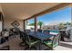 Outdoor patio and dining area adjacent to a sparkling pool and manicured landscaping at 16747 W Berkeley Rd, Goodyear, AZ 85395
