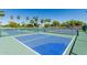 Pickleball court with net on a well-maintained surface for sports and active community lifestyle at 16747 W Berkeley Rd, Goodyear, AZ 85395