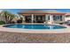 Backyard pool featuring covered patio with outdoor seating and desert landscaping, perfect for entertaining and relaxation at 16747 W Berkeley Rd, Goodyear, AZ 85395