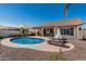 Backyard pool area featuring desert landscaping, a covered patio, and outdoor seating for entertaining at 16747 W Berkeley Rd, Goodyear, AZ 85395