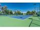 Well-maintained tennis court with green and blue surface, providing recreational opportunities for residents at 16747 W Berkeley Rd, Goodyear, AZ 85395