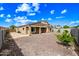 A low-maintenance backyard featuring a gravel bed, a square grass patch, and a block wall at 16763 W Magnolia St, Goodyear, AZ 85338