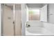 Bright bathroom featuring a large soaking tub and a walk-in shower with glass door and tile surround at 16763 W Magnolia St, Goodyear, AZ 85338