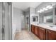 A spacious Primary bathroom featuring double sinks, tile flooring, a bathtub, and a separate walk-in shower at 16763 W Magnolia St, Goodyear, AZ 85338
