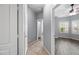 View of bedroom with gray walls, a ceiling fan, wood floors, and white shutters on the windows at 16763 W Magnolia St, Goodyear, AZ 85338