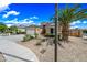 Beautiful single-story home with desert landscaping, palm tree, and ample driveway at 16763 W Magnolia St, Goodyear, AZ 85338