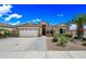 Charming single-story home with a well-manicured front yard and a two-car garage at 16763 W Magnolia St, Goodyear, AZ 85338