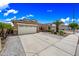 Attractive single-story home with a two-car garage, desert landscaping, and large driveway at 16763 W Magnolia St, Goodyear, AZ 85338