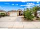 Charming single-story home with a two-car garage, desert landscaping and a beautiful blue sky at 16763 W Magnolia St, Goodyear, AZ 85338