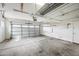 Inside a spacious garage with a concrete floor, white walls, and an open garage door at 16763 W Magnolia St, Goodyear, AZ 85338