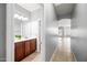 Hallway leading to bathroom with vanity at 16763 W Magnolia St, Goodyear, AZ 85338
