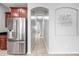 Hallway featuring a stainless steel refrigerator and an arched ceiling feature at 16763 W Magnolia St, Goodyear, AZ 85338