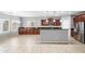 Kitchen with stainless steel appliances, a kitchen island, and an adjoining dining area at 16763 W Magnolia St, Goodyear, AZ 85338
