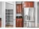Spacious kitchen with a stainless steel refrigerator and pantry at 16763 W Magnolia St, Goodyear, AZ 85338