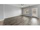 Bright living room with hardwood flooring, neutral paint, and window with shutter at 16763 W Magnolia St, Goodyear, AZ 85338