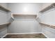 Spacious walk-in closet featuring multiple levels of shelving and a gray wood-look floor at 16763 W Magnolia St, Goodyear, AZ 85338