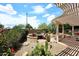Picturesque backyard with a built-in firepit, pergola, lush desert landscaping, and privacy at 17630 N Somerset Dr, Surprise, AZ 85374