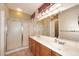 Bathroom featuring double sinks, stylish vanities, shower and tiled floors at 17630 N Somerset Dr, Surprise, AZ 85374