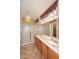 Bathroom featuring double sinks, stylish vanities, shower and tiled floors at 17630 N Somerset Dr, Surprise, AZ 85374