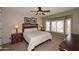 Cozy bedroom with a large window, carpet, and a ceiling fan at 17630 N Somerset Dr, Surprise, AZ 85374