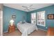 Comfortable bedroom featuring a ceiling fan and natural light from the window at 17630 N Somerset Dr, Surprise, AZ 85374