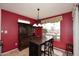Bright dining room with elegant light fixture, and backyard views at 17630 N Somerset Dr, Surprise, AZ 85374