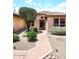 Inviting front entrance with desert landscaping and walkway leading to the front door at 17630 N Somerset Dr, Surprise, AZ 85374