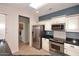 Kitchen featuring granite countertops, stainless appliances, tile floors, and ample natural light at 17630 N Somerset Dr, Surprise, AZ 85374