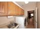 Laundry area equipped with modern washer and dryer set, cabinetry, and a sink for added convenience at 17630 N Somerset Dr, Surprise, AZ 85374